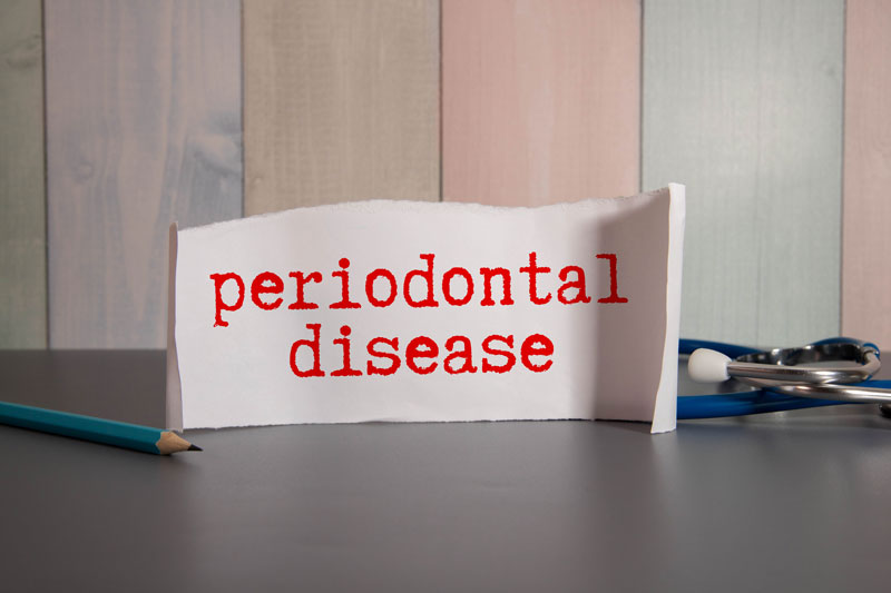 a sign that says "periodontal disease" with some tools around it